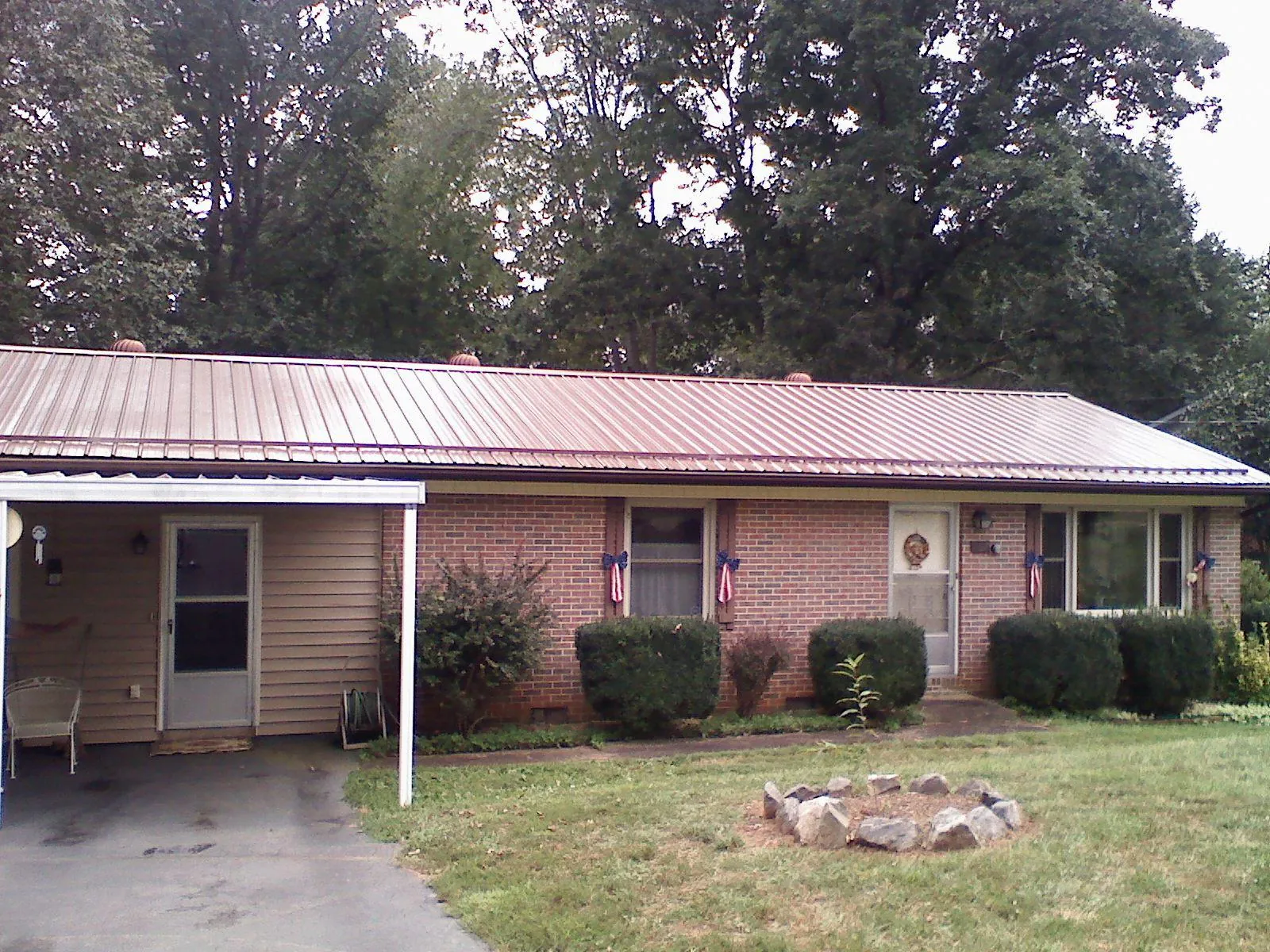 Bronze metal roof and carport on a brick ranch home — Roof Repair work by our crew in Singers Glen